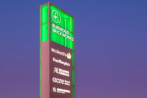 Burwood Brickworks Pylon sign night exterior with green neon illumination