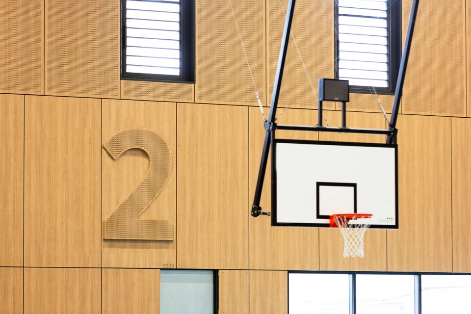 Perforated timber court number in gymnasium
