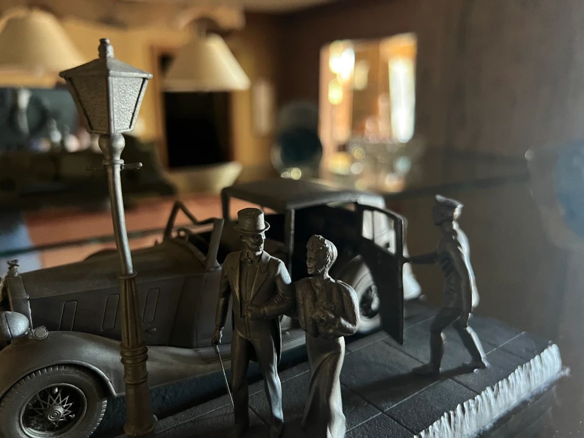 Miniature vintage street scene with car, lamppost, and figures from a Toluca Lake estate sale collection.