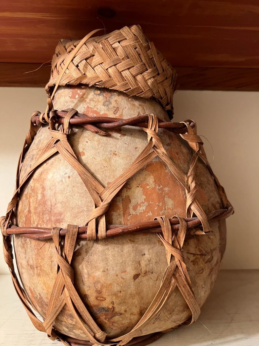 Rustic woven gourd vessel with natural fiber wrapping from a Toluca Lake estate sale art and decor collection.