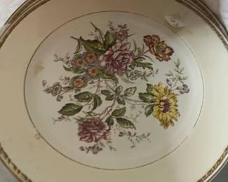 Decorative floral china plate with cream glaze and gold trim, featured among fine china and tableware in a Beverly Hills estate sale.