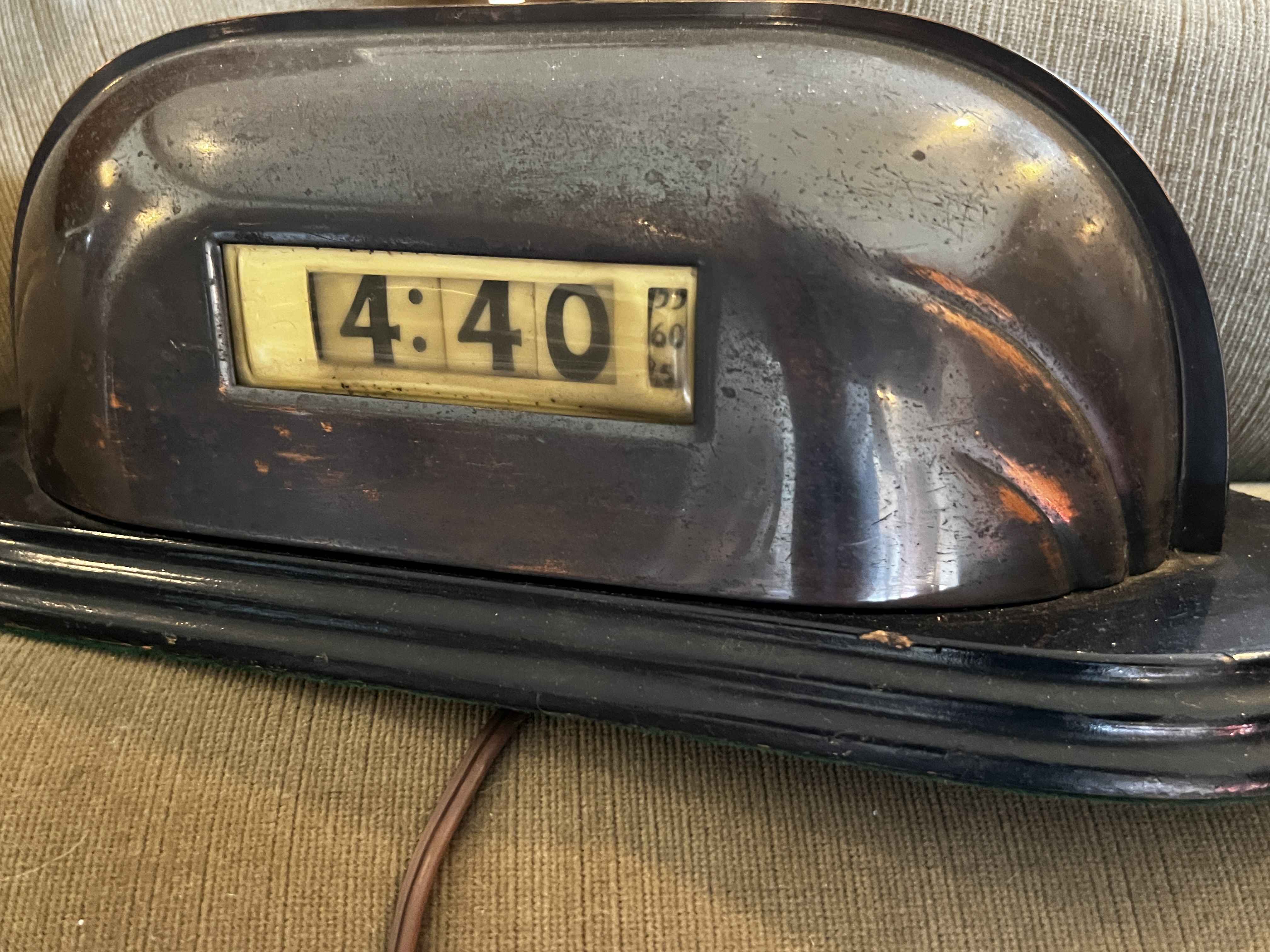Vintage flip clock with dark rounded case showing 4:40, from a Hancock Park celebrity estate sale filled with antiques, decor, and Hollywood collectibles.