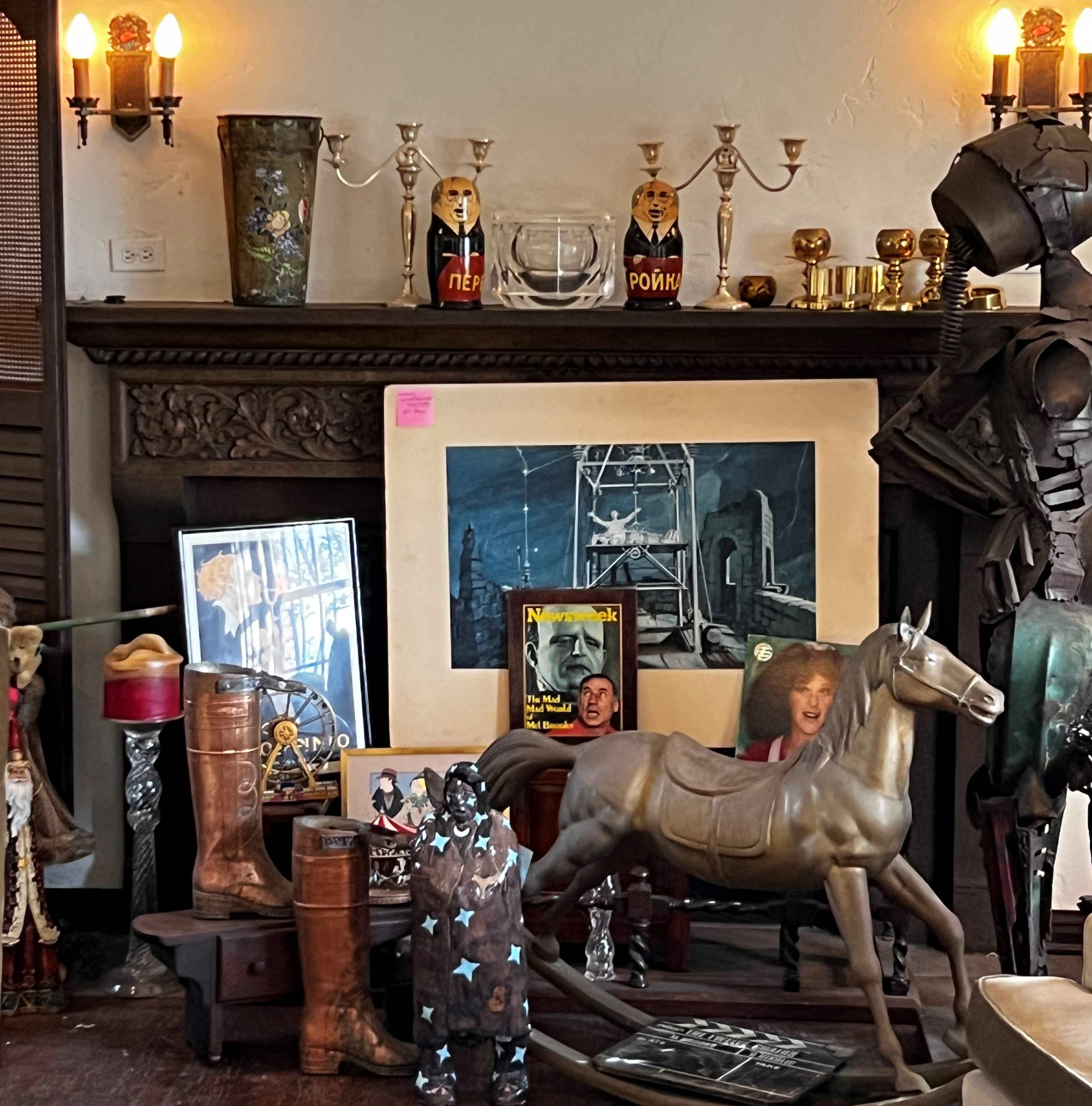 Hancock Park celebrity estate sale display with antiques, Hollywood memorabilia, art, vintage decor, rocking horse, brass pieces, and theatrical collectibles.