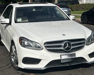 White 2016 Mercedes-Benz E 350 sedan with tan interior, featured as a pre-sale automobile highlight in a Studio City estate sale.
