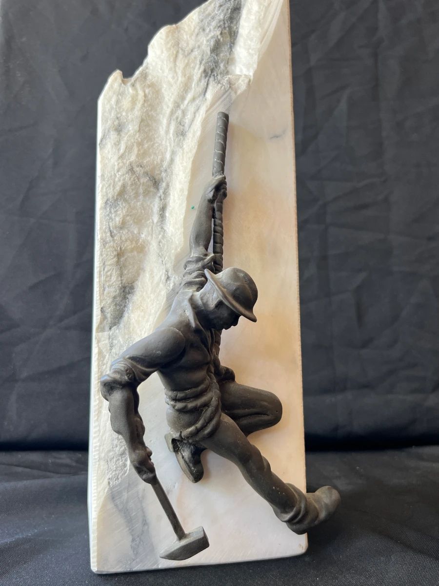 Climber sculpture mounted on a stone slab from a Toluca Lake estate sale art collection.