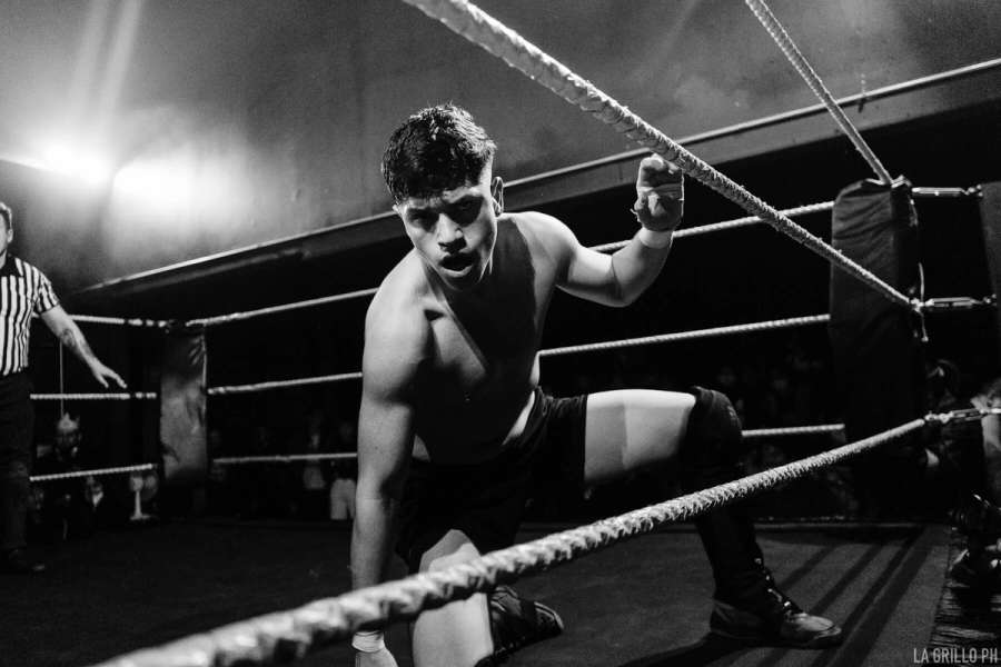 Eric arrodillado cerca de las cuerdas sobre le ring
