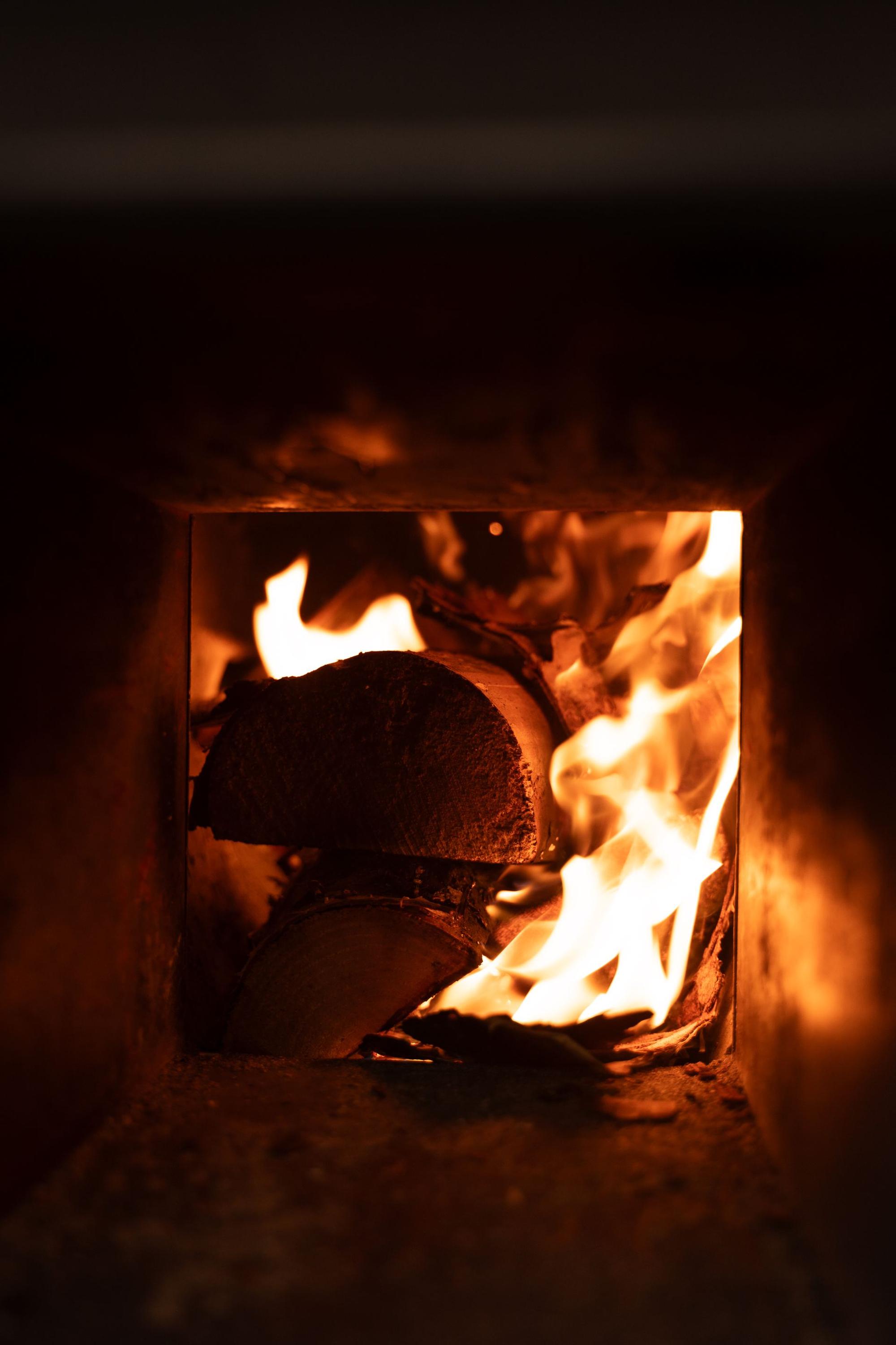 The wood-fired stove glowing inside the sauna