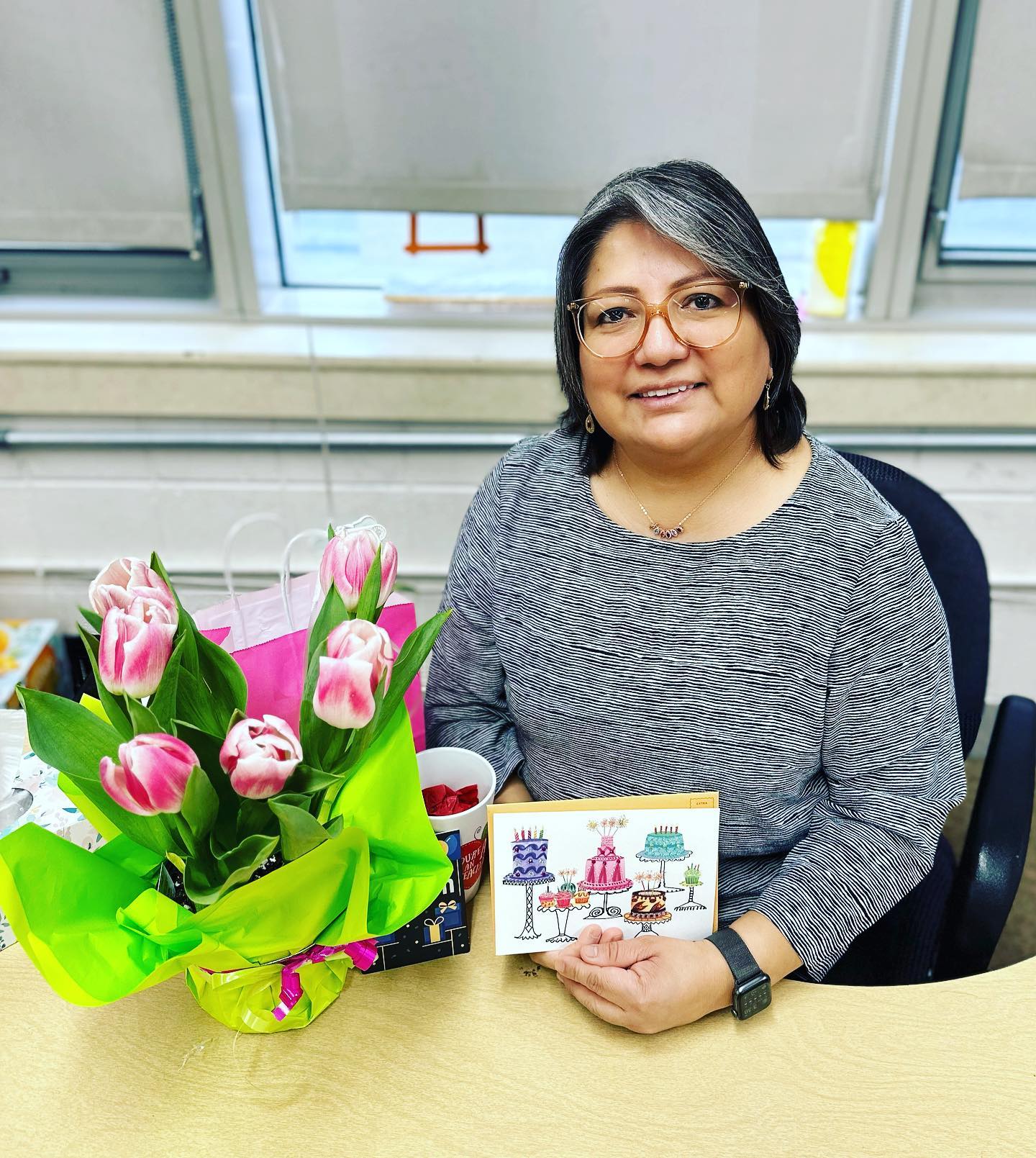 cmendez sitting in classroom holding a birthday card