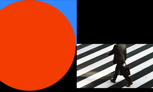 A man walking across a crosswalk with a briefcase