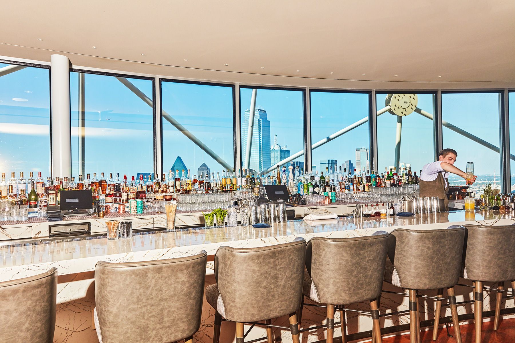 The Crown Block bar with floor-to-ceiling windows over the Dallas skyline