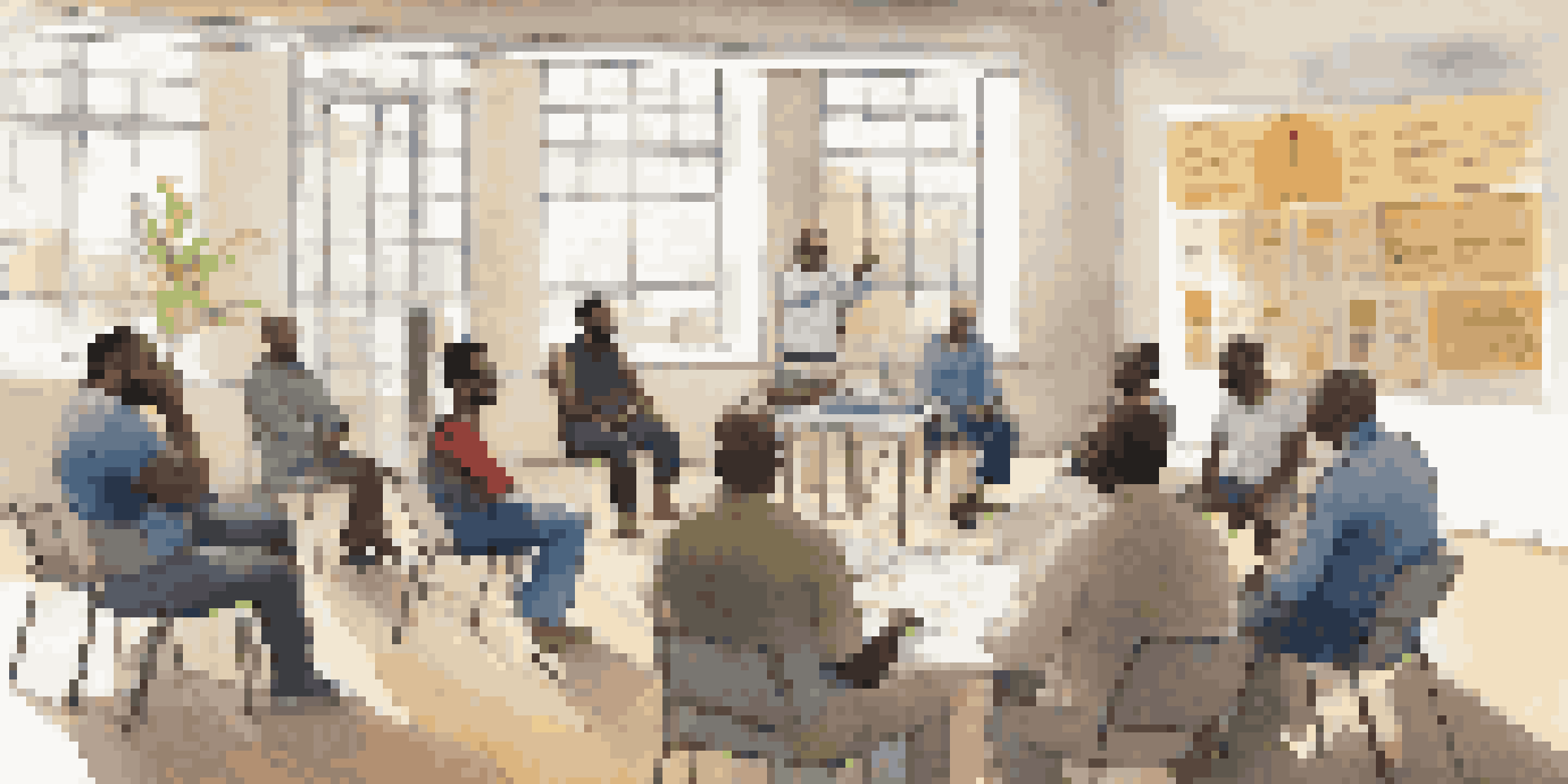 A community health workshop where diverse men are engaged in discussions, with a facilitator presenting information.