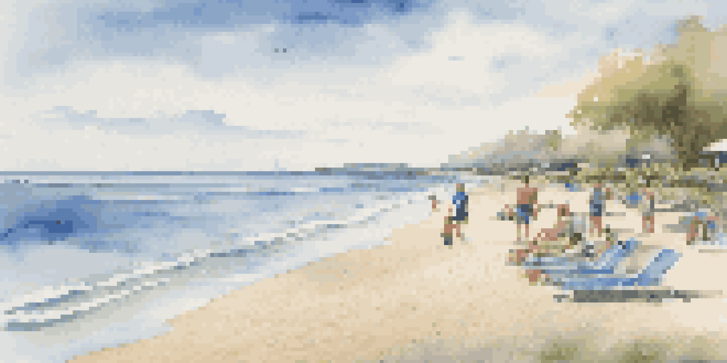 A peaceful beach with accessible pathways, beachgoers relaxing under umbrellas, and gentle waves in the background.