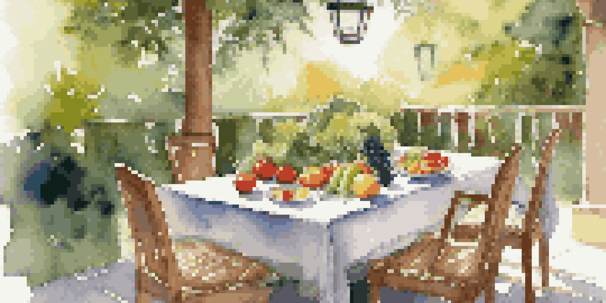 A peaceful outdoor dining table filled with fresh fruits and vegetables, surrounded by greenery and sunlight.