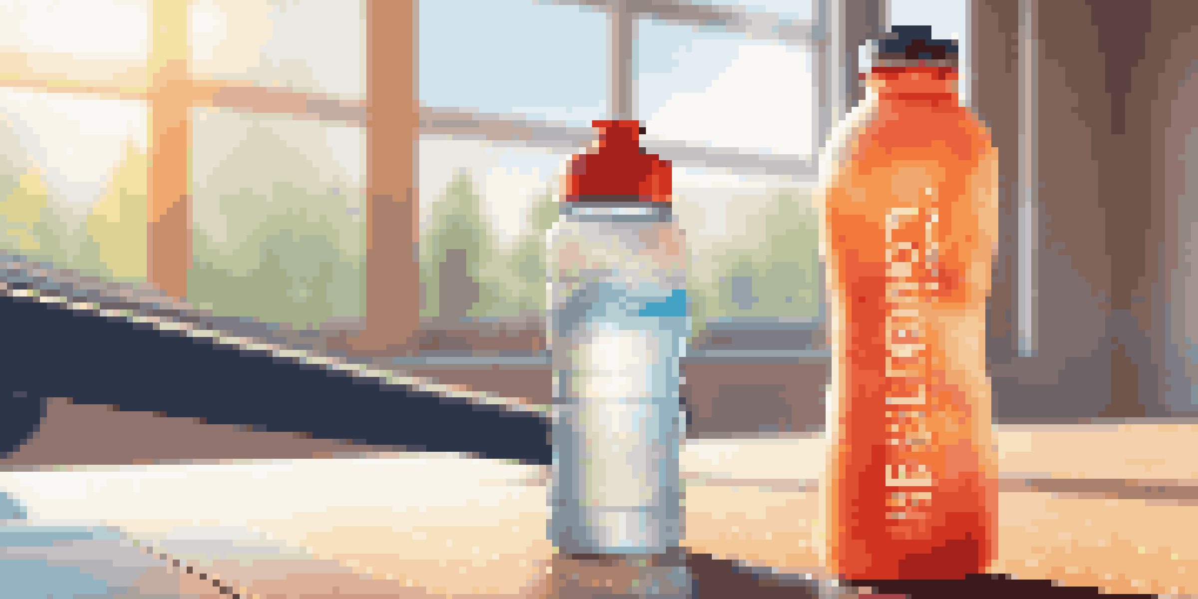 A close-up of a colorful sports water bottle and a blurred athlete running in the background, emphasizing the importance of hydration in fitness.