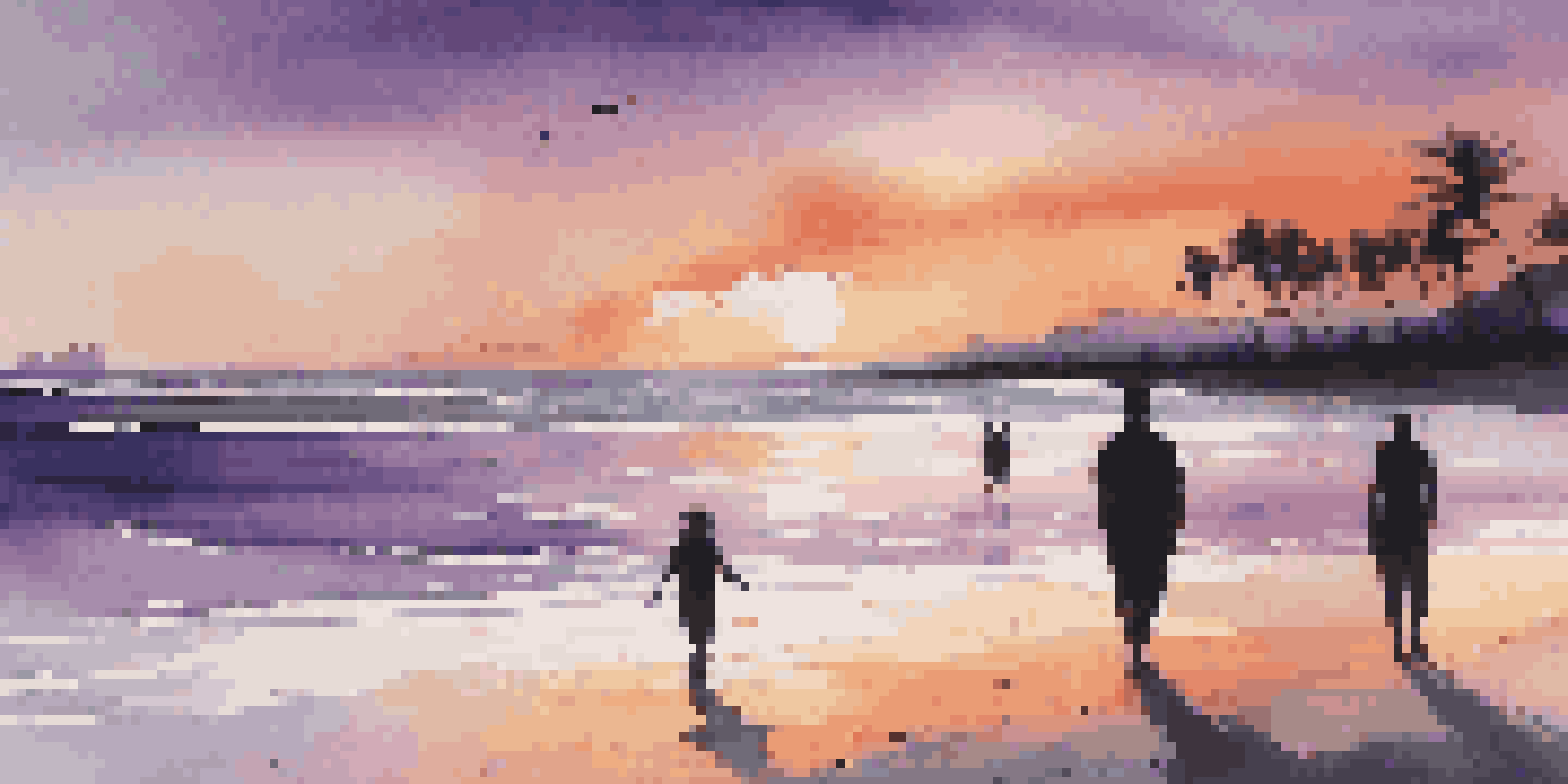 A couple walking hand in hand on a beach at sunset, with vibrant colors in the sky and gentle waves.