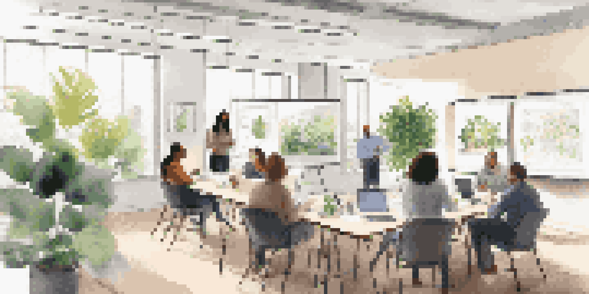 A diverse group of employees participating in a financial wellness workshop in a bright office with plants and a whiteboard displaying budgeting tips.