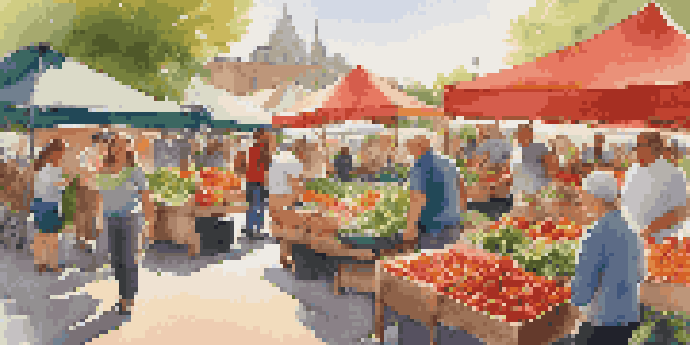 A bustling farmers' market with bright fruits and vegetables and people shopping.