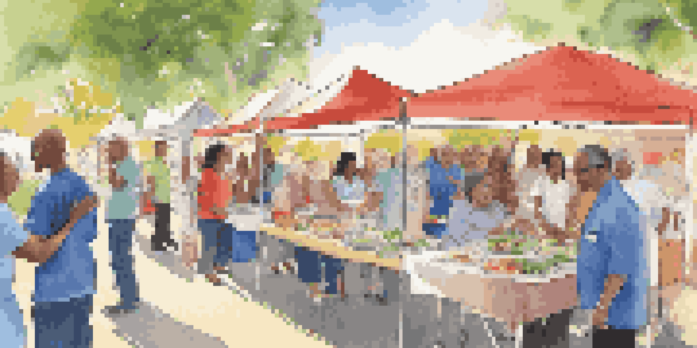 A lively community health fair with diverse attendees engaging with healthcare providers, showcasing colorful booths and a cooking demonstration.