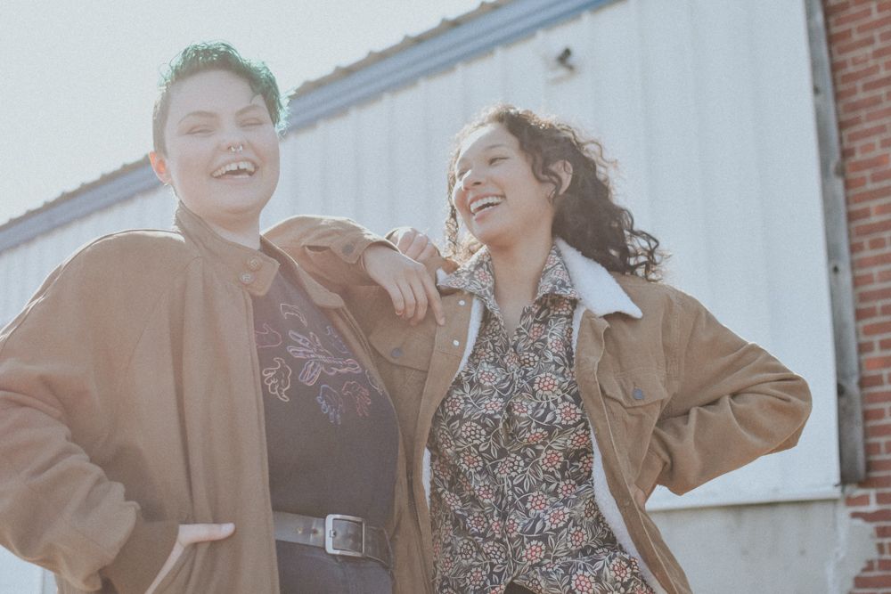 Kyah smiling in the sun with a friend. Photo credit WCKD collective.