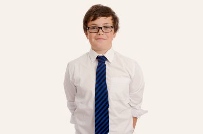 A young boy wearing a shirt and tie 
