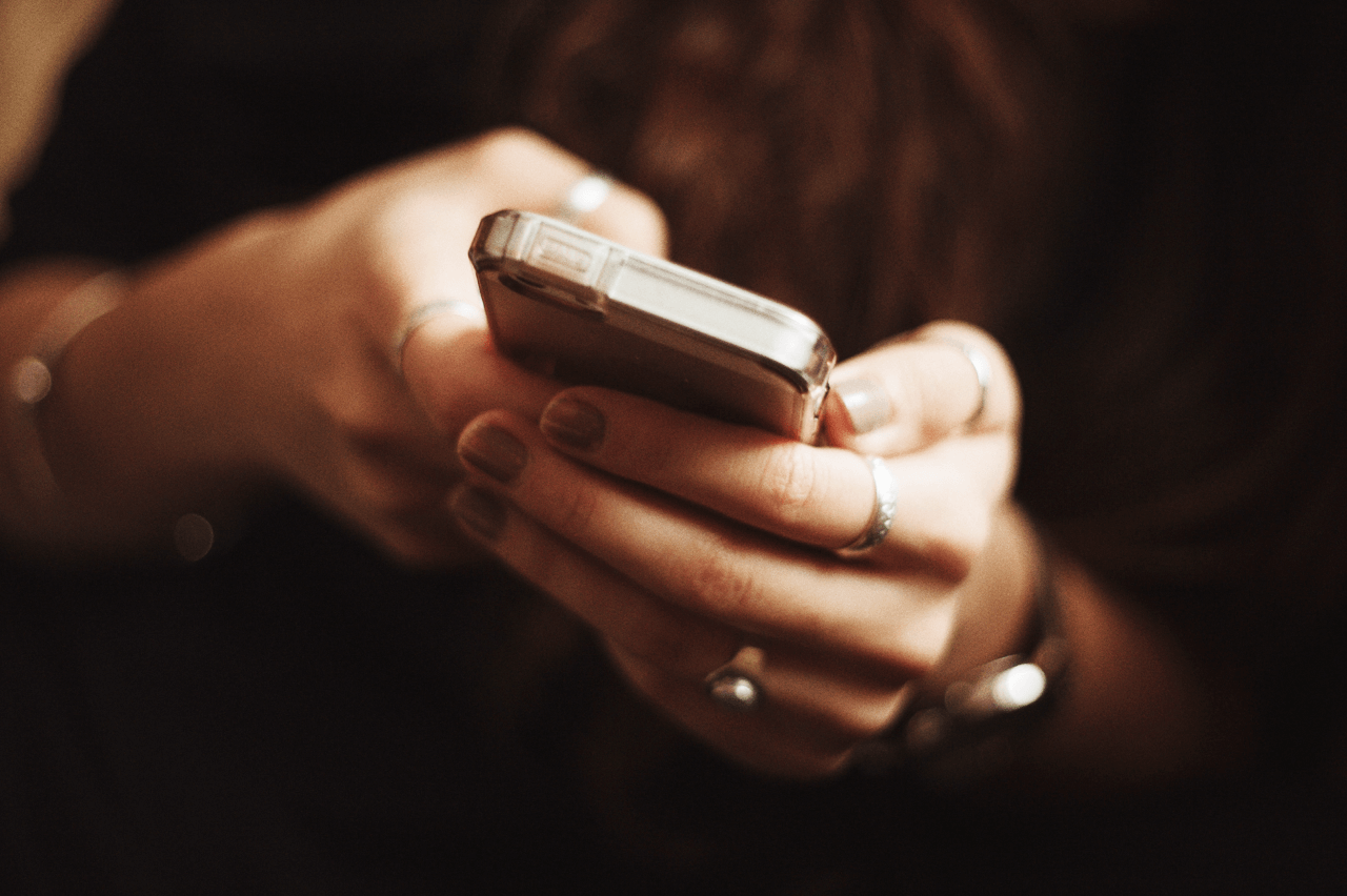 Close up of a woman's hand holding a phone 