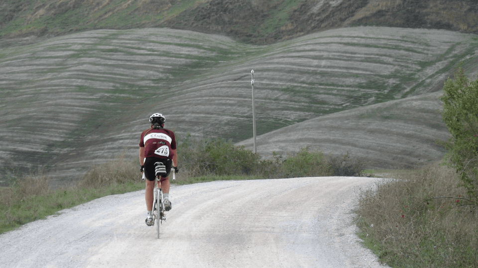 Man riding gravel bike on dirt road