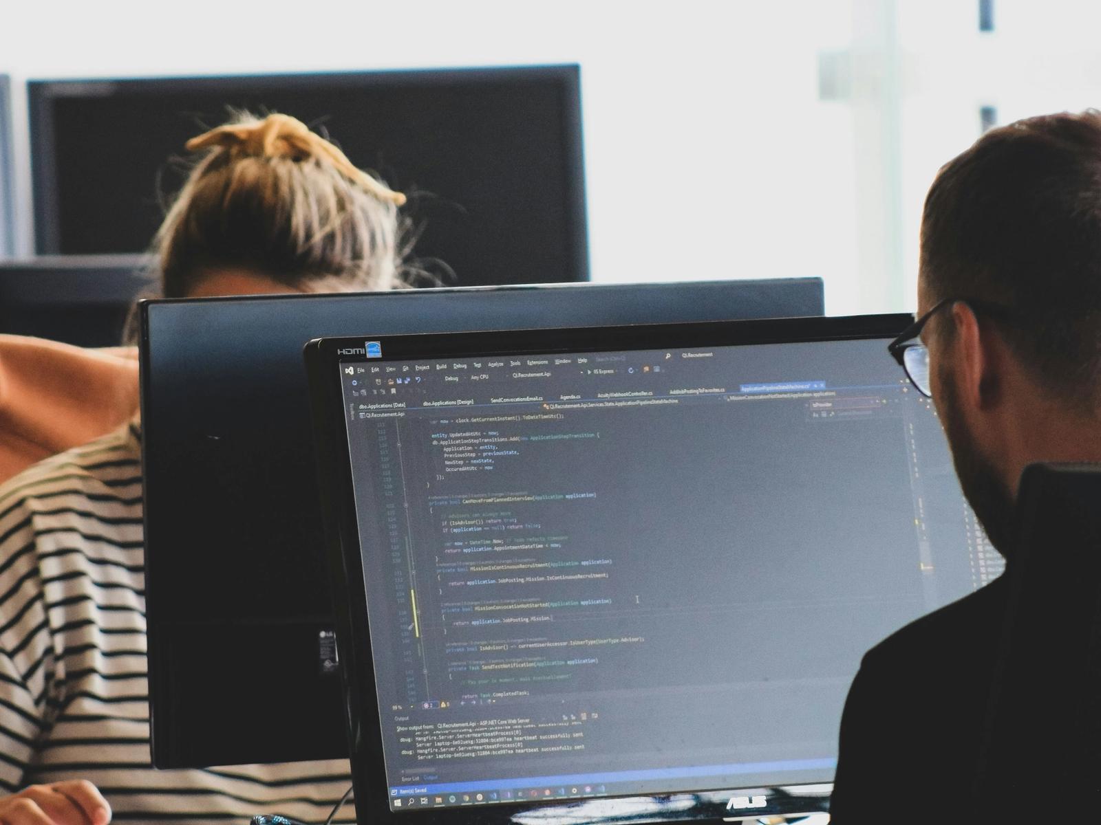Developers working on application code at their desks