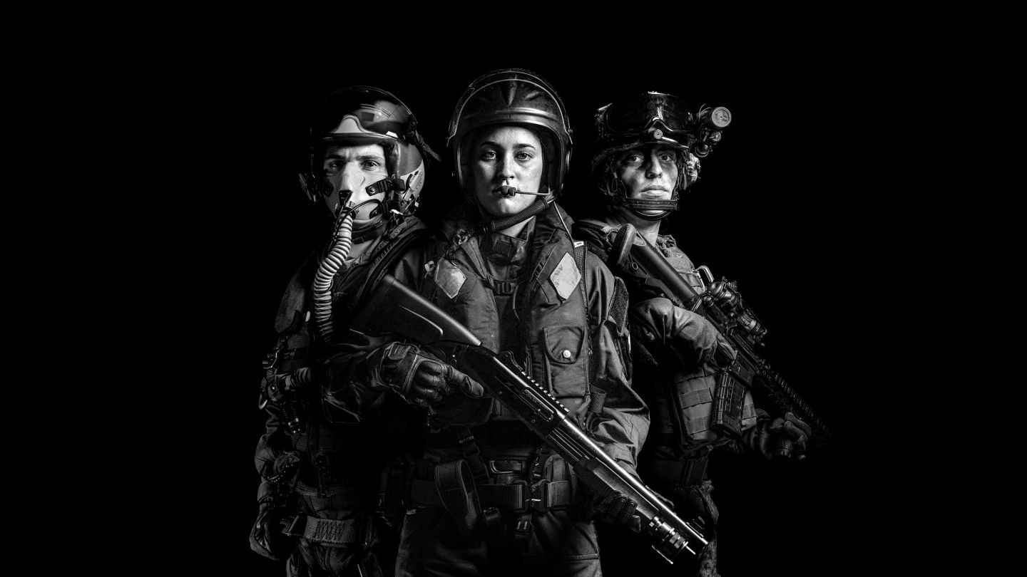 A black and white photograph depicting personnel from the New Zealand Defence Force. The image includes representatives from all three branches: the Army, Navy, and Air Force.