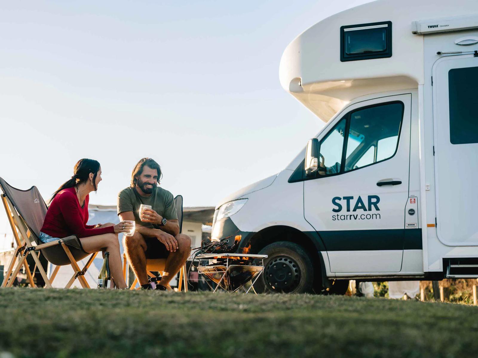 Couple enjoying a coffee by their Star RV camper