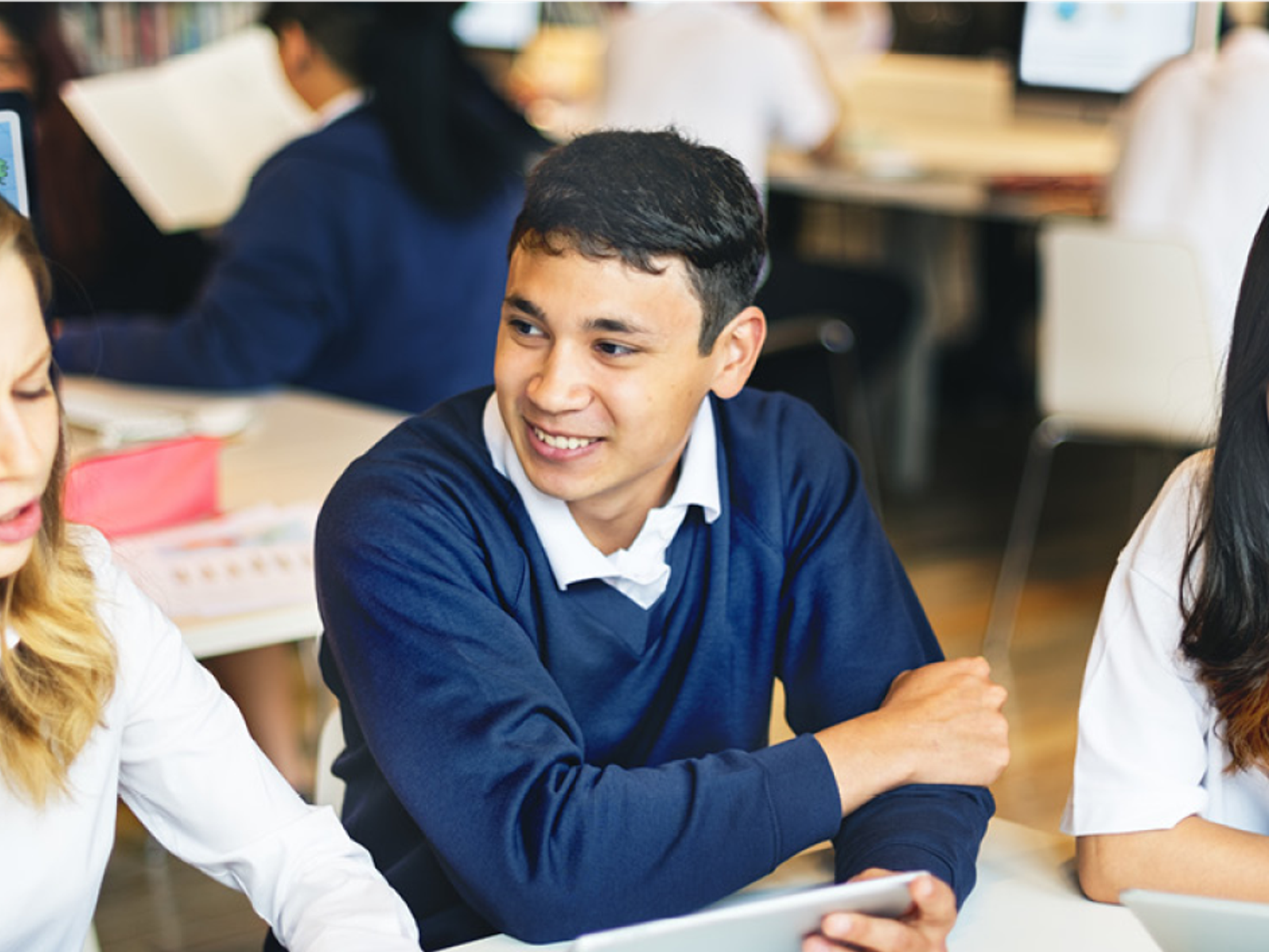 A group of three children in a classroom