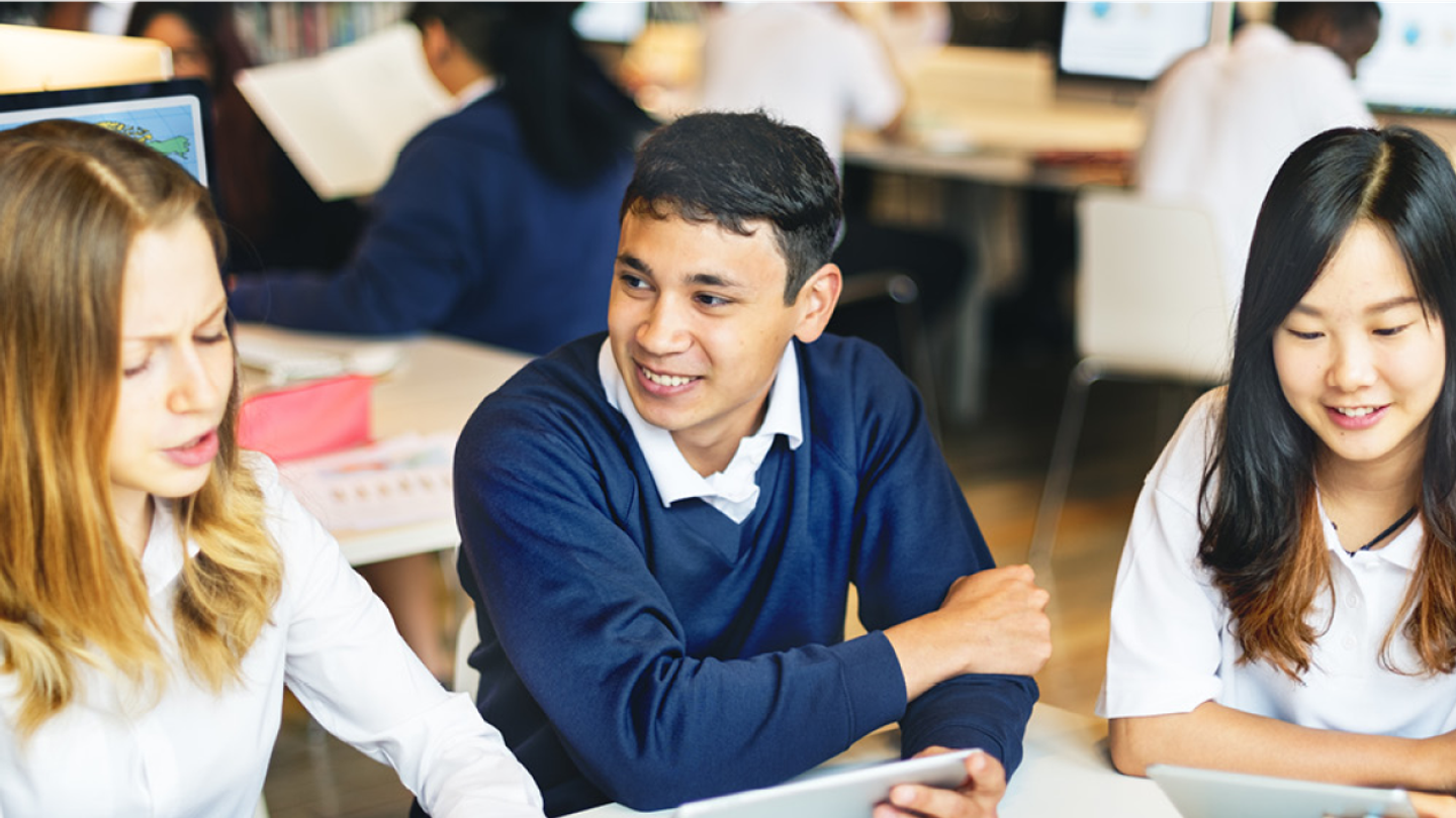 A group of three children in a classroom