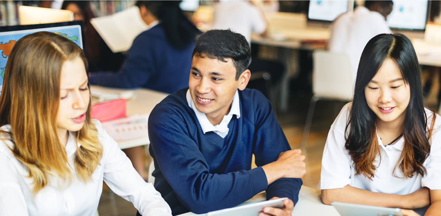A group of three children in a classroom