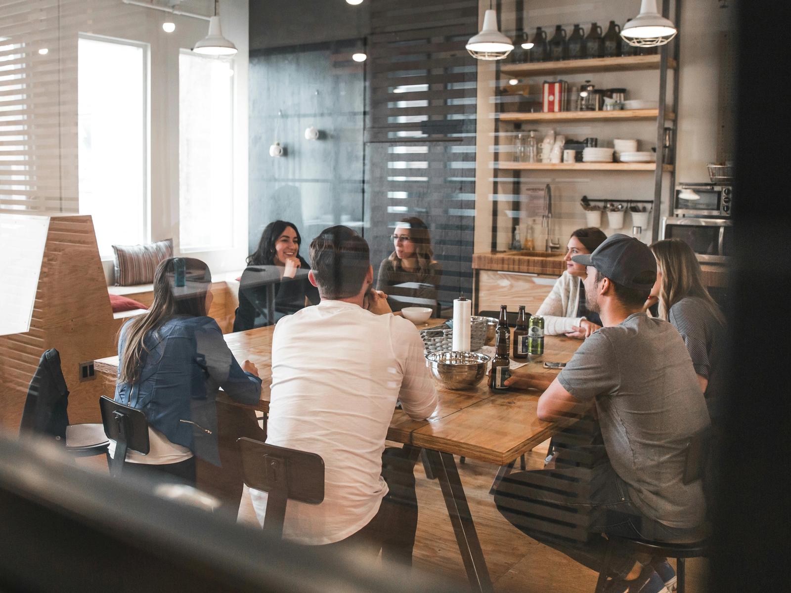 A project team discussing their work around a meeting table