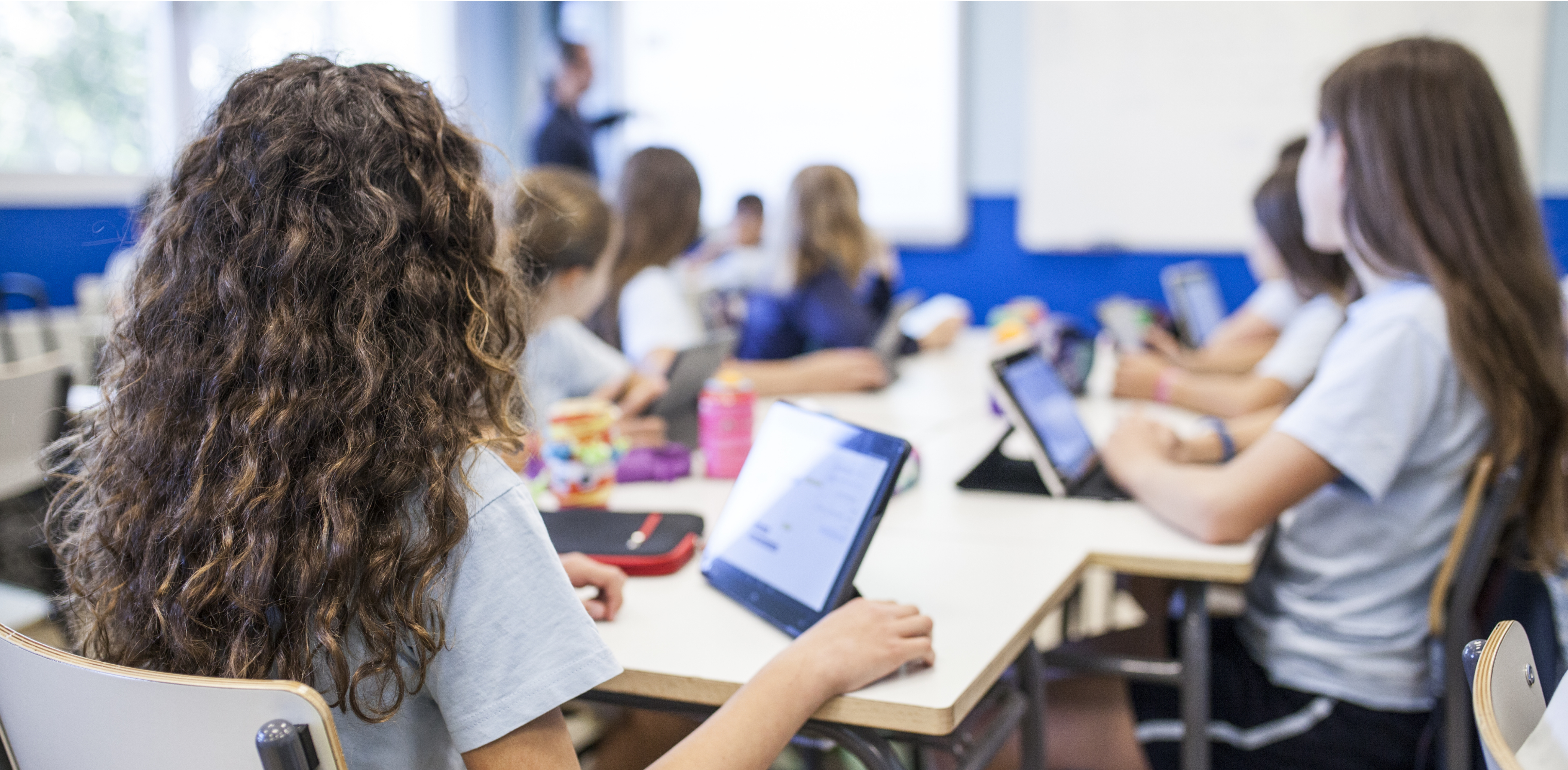 Image of a classroom showing a full class of children using iPads