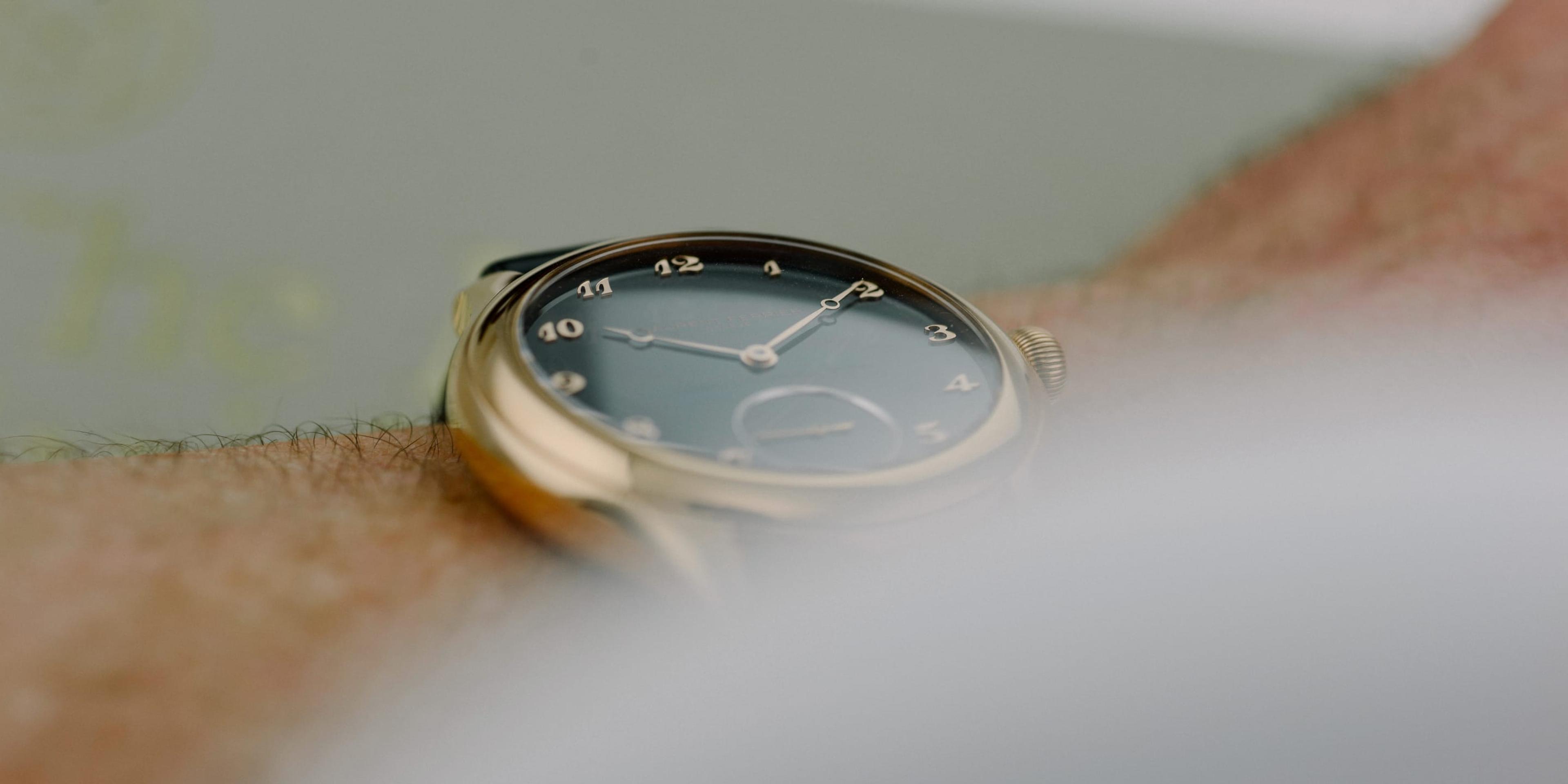 A watch with a gold face