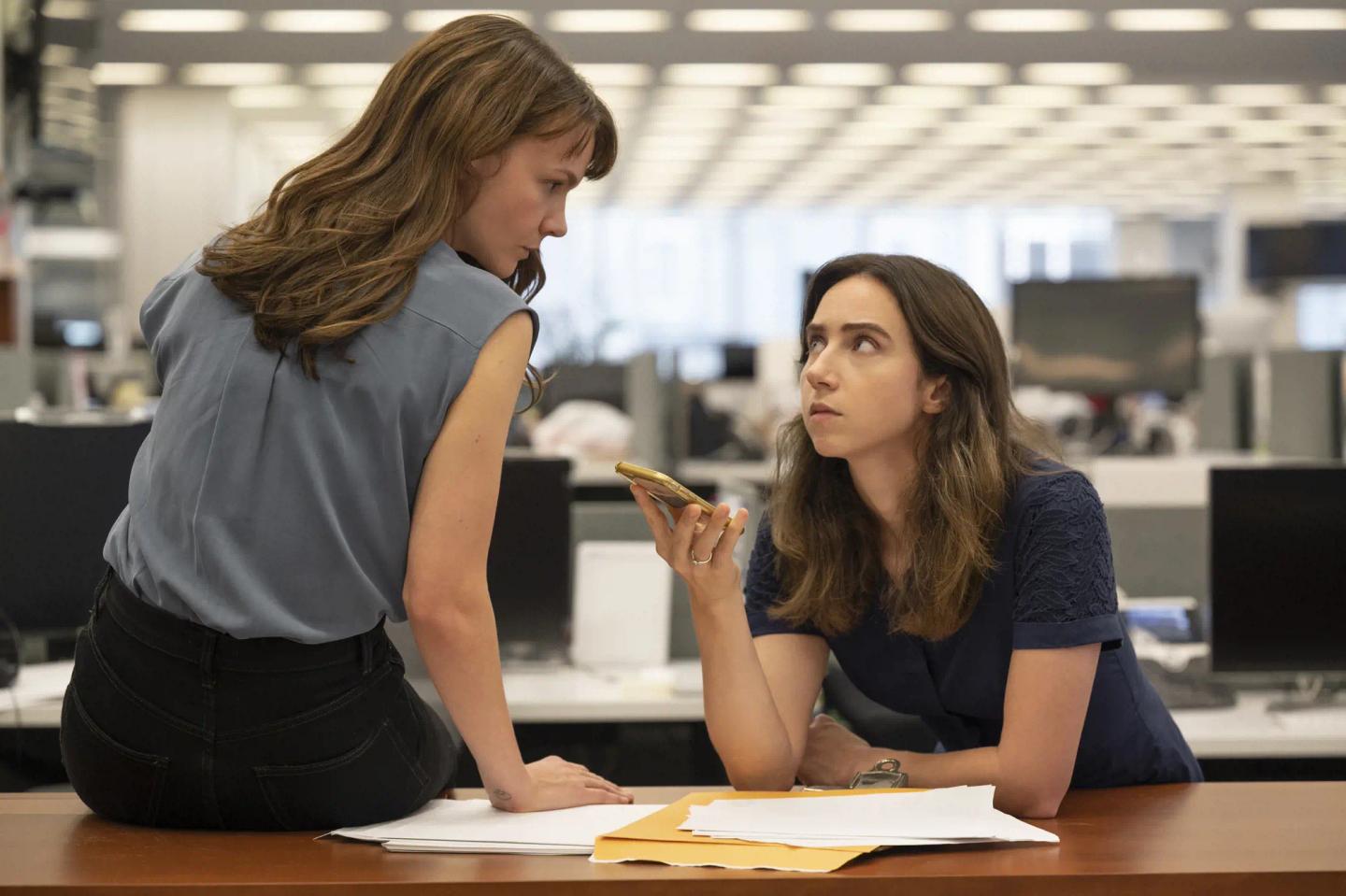 Zoe Kazan showing something to another woman