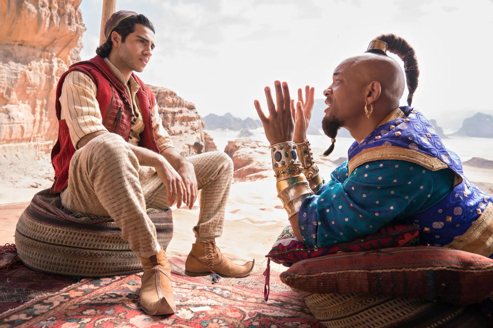 a man and woman sitting on a rug with their hands up