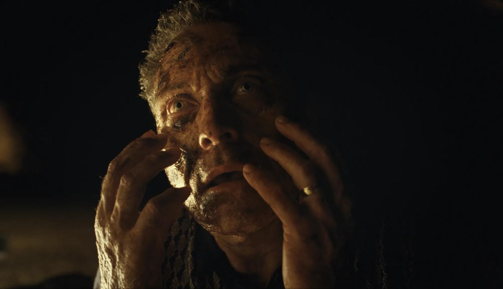 a man with his hands on his face