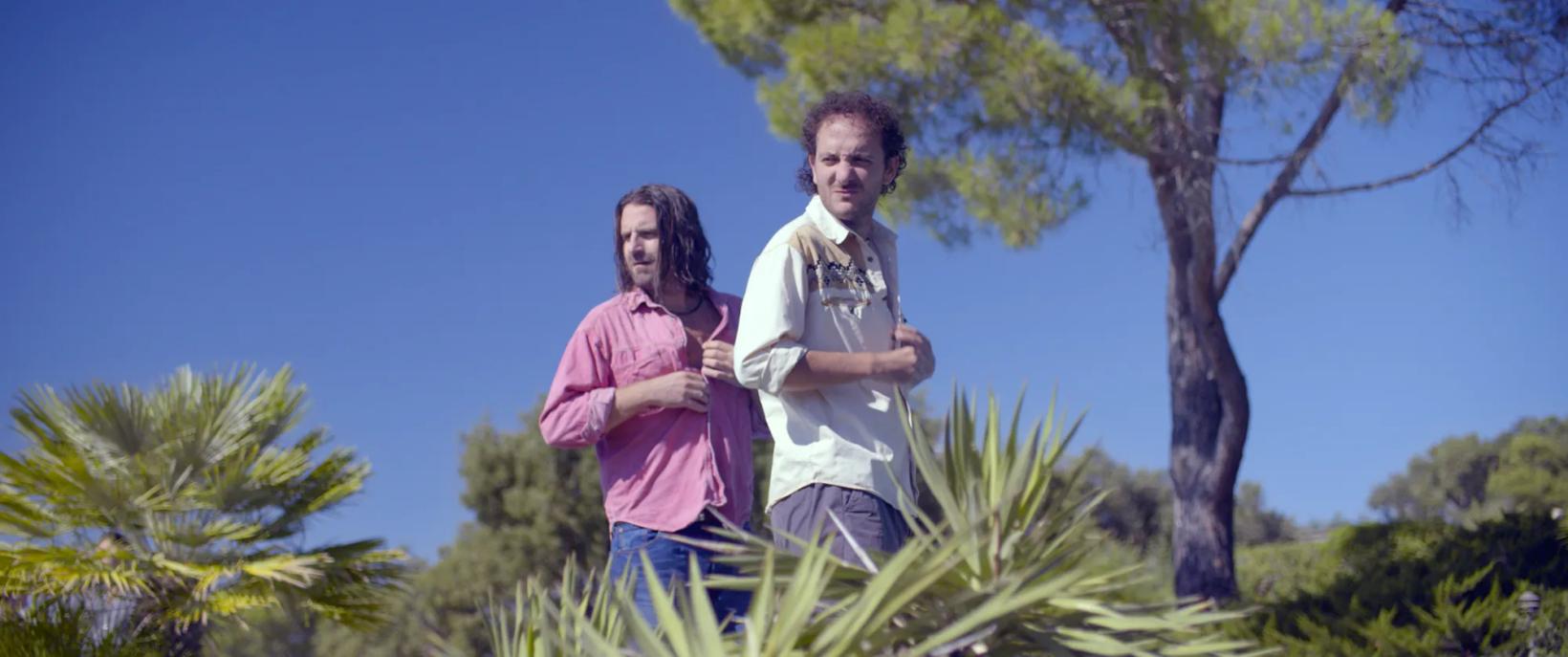 a man and woman standing next to each other in front of a tree