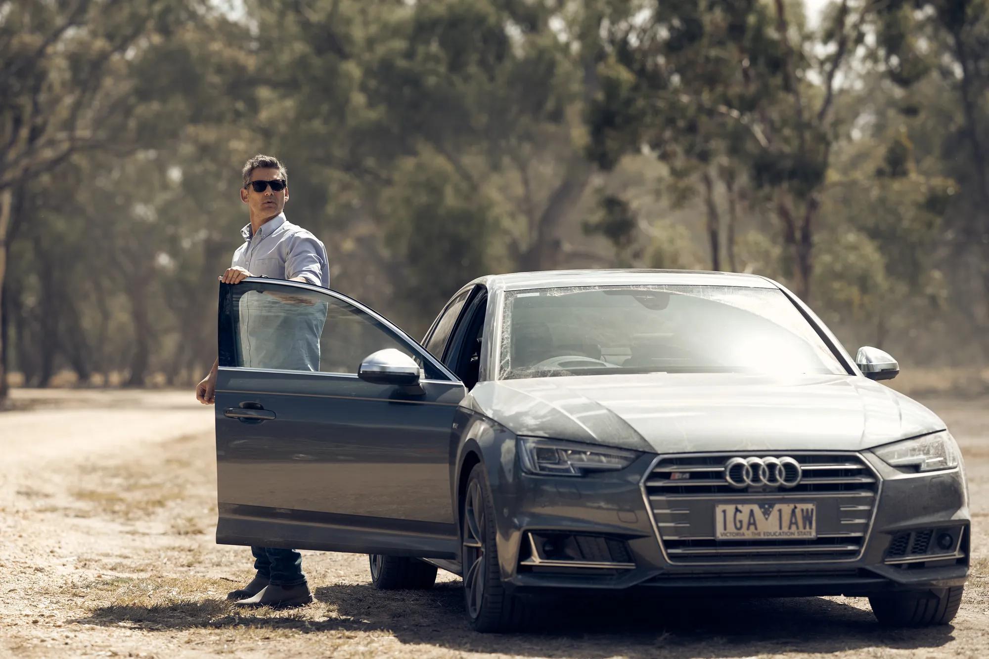 a person standing next to a car