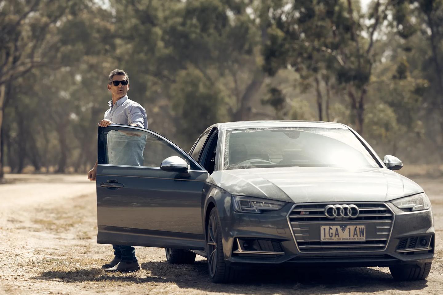 a person standing next to a car