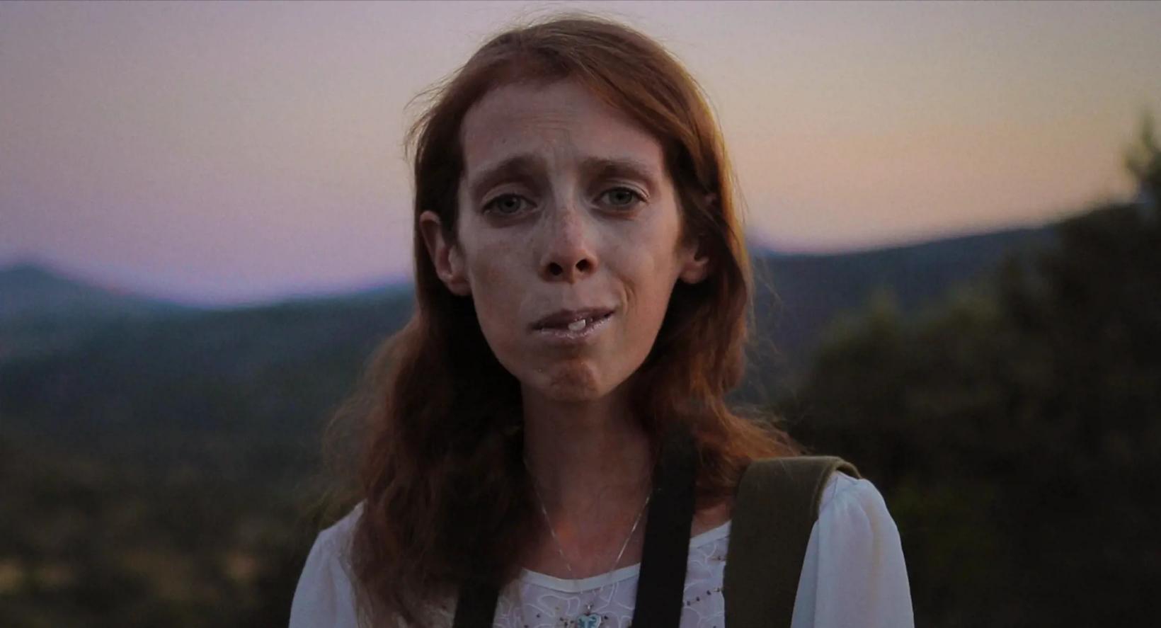 a woman with her hand on her chin