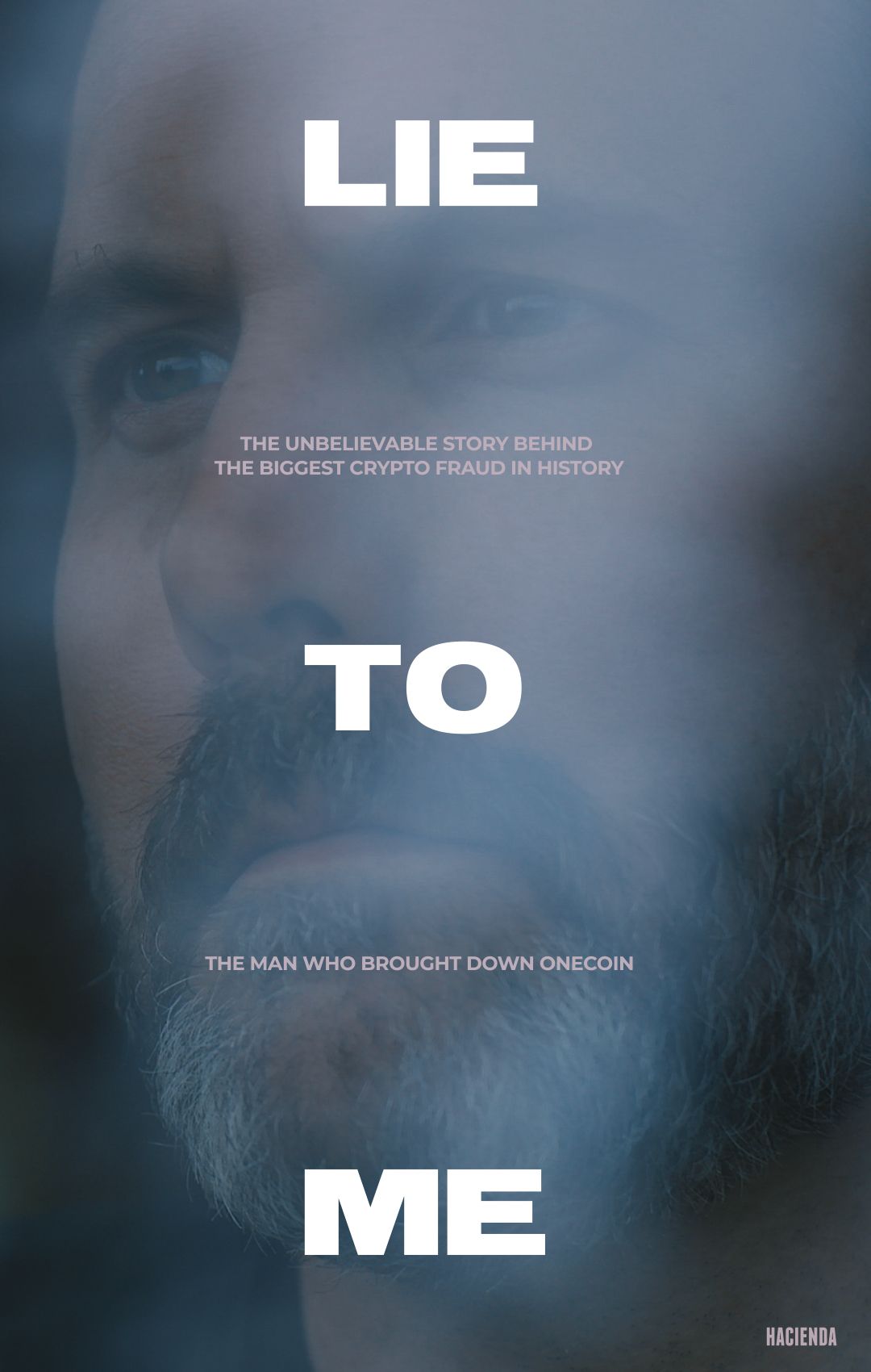 a man looking at a wall of photographs