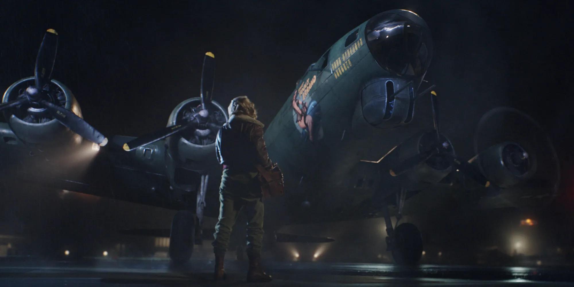 a person standing next to a plane