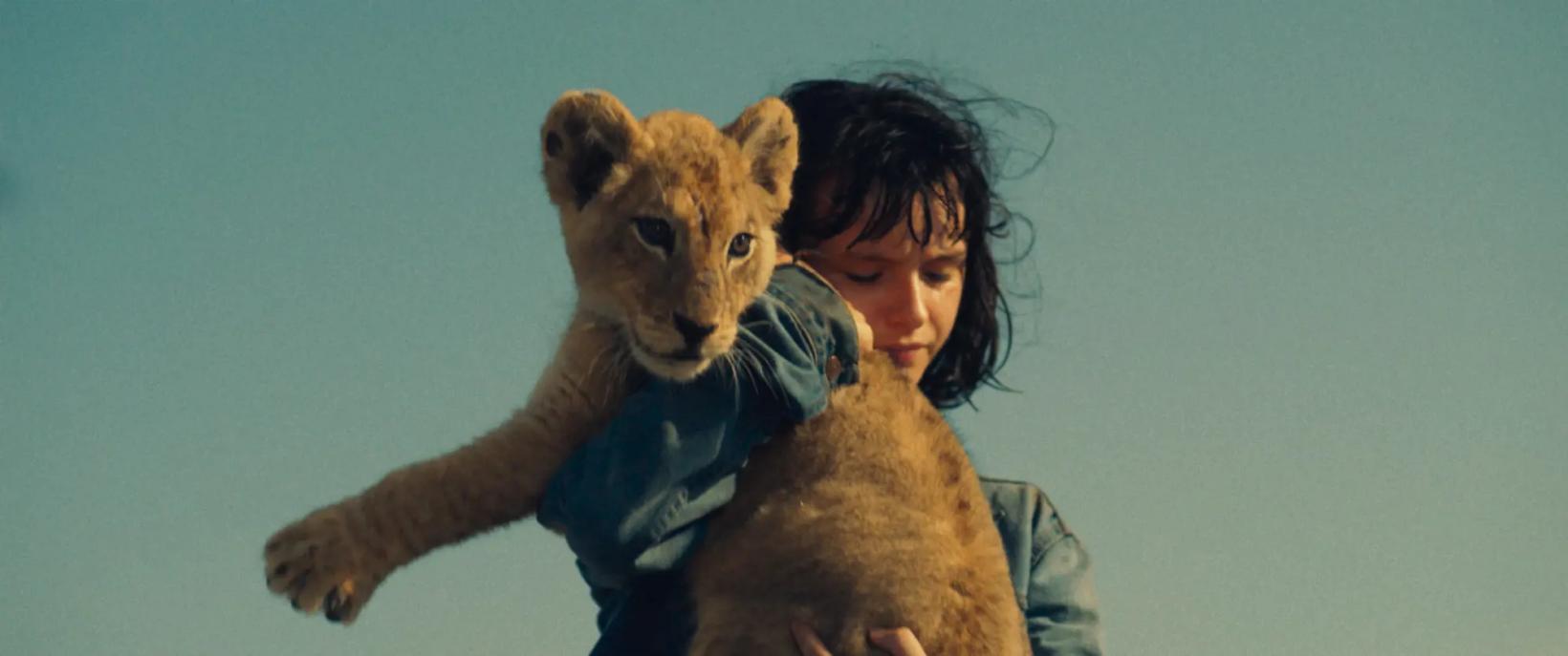 a person holding a lion
