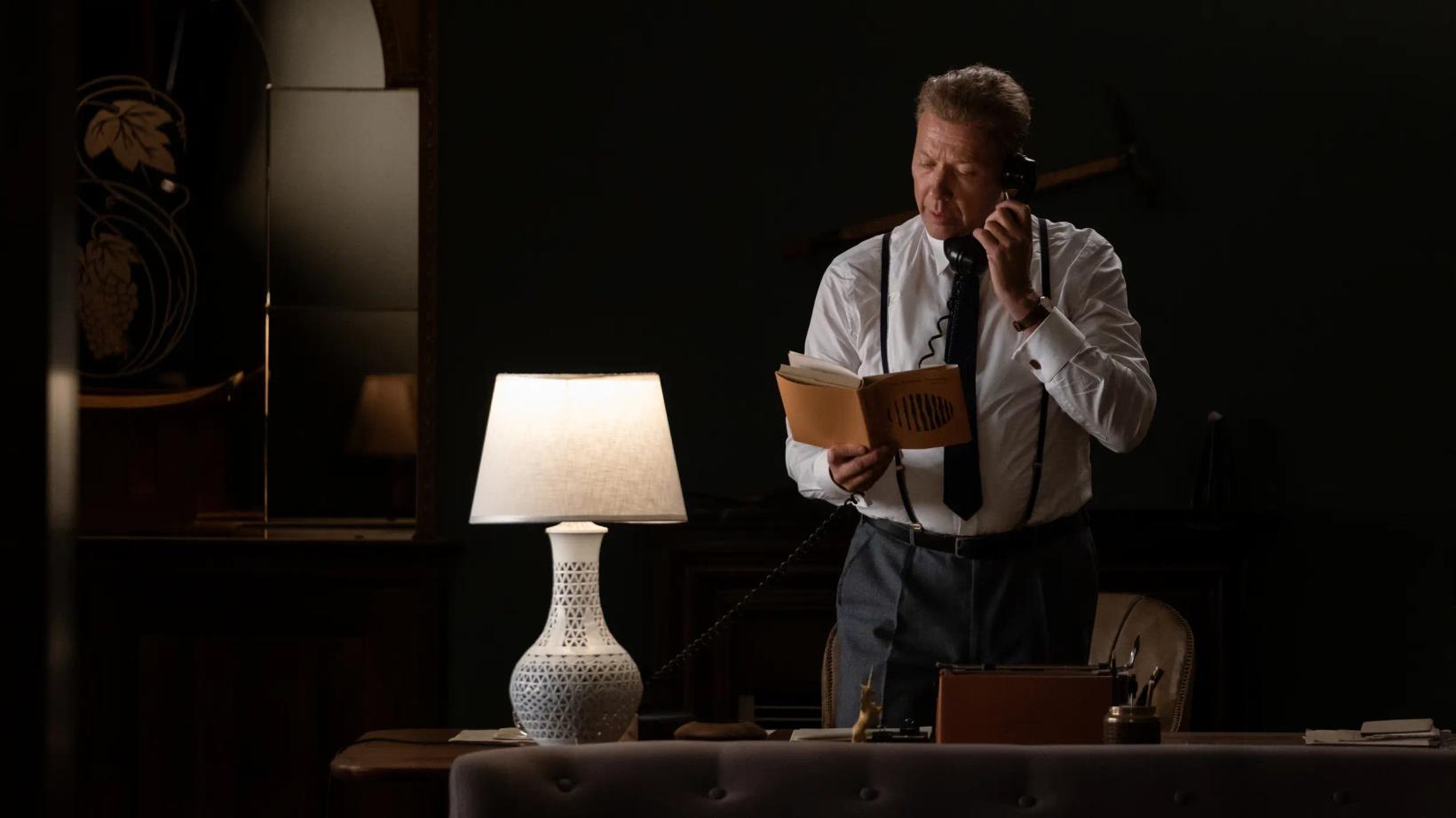 a man holding a microphone and a book