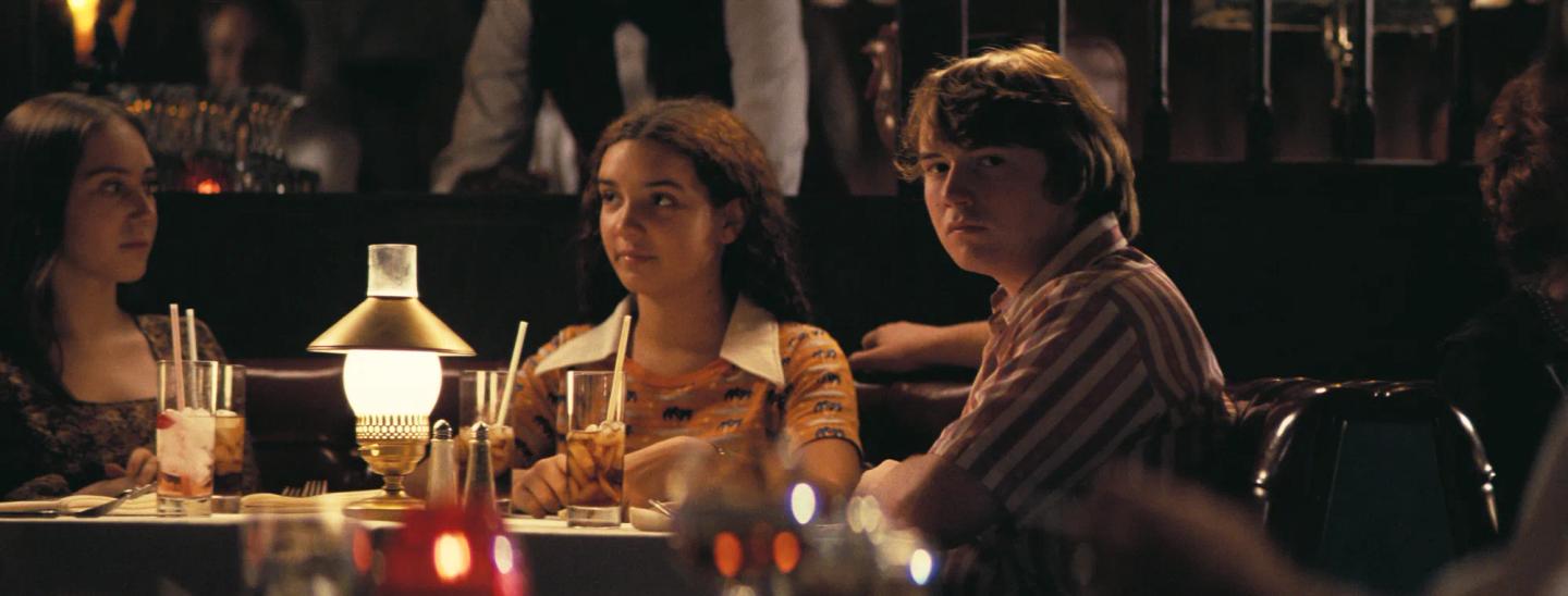 a group of people sitting at a table with drinks