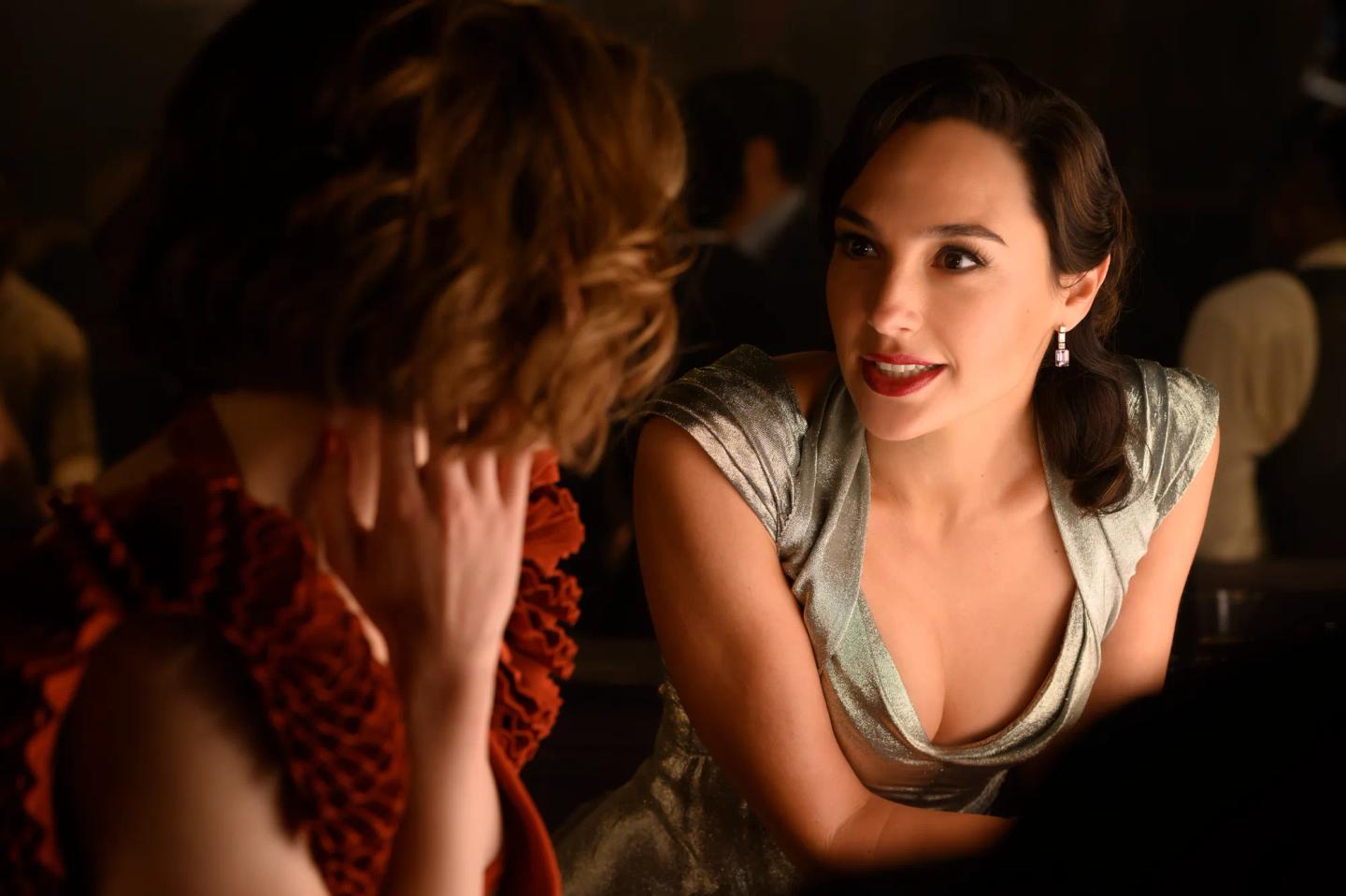 Gal Gadot with the hand on the face looking at another woman