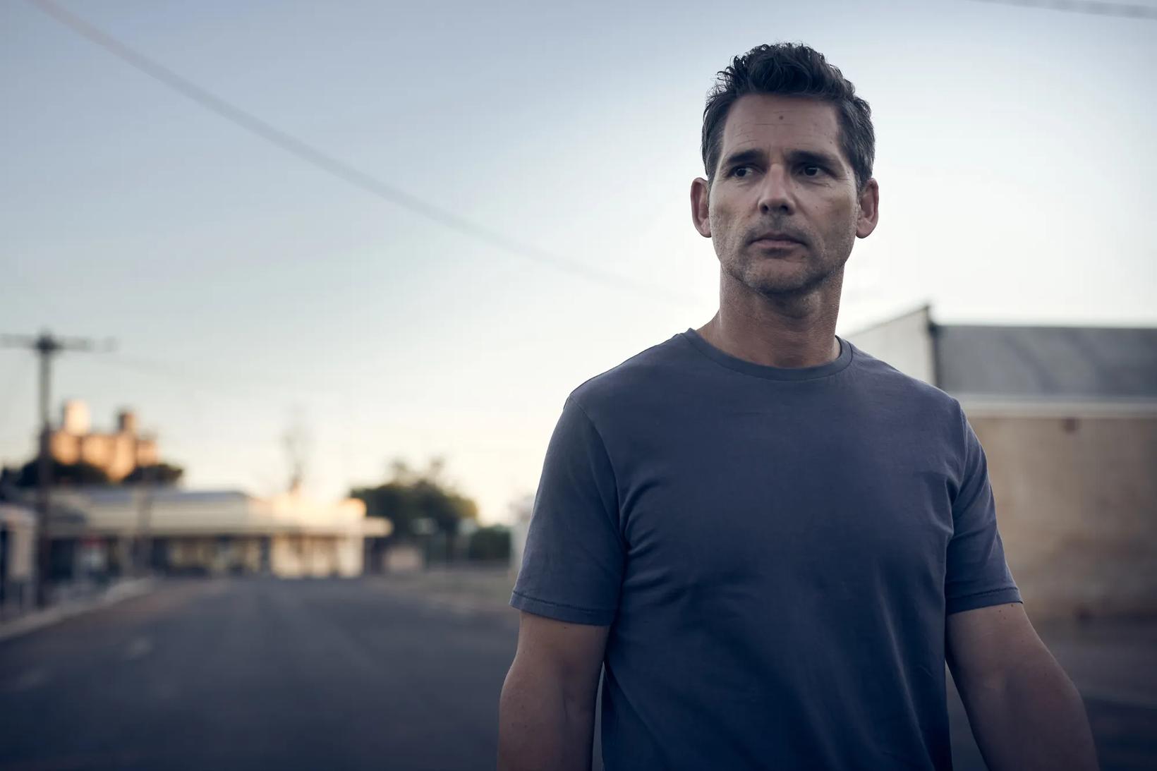 Eric Bana standing outside