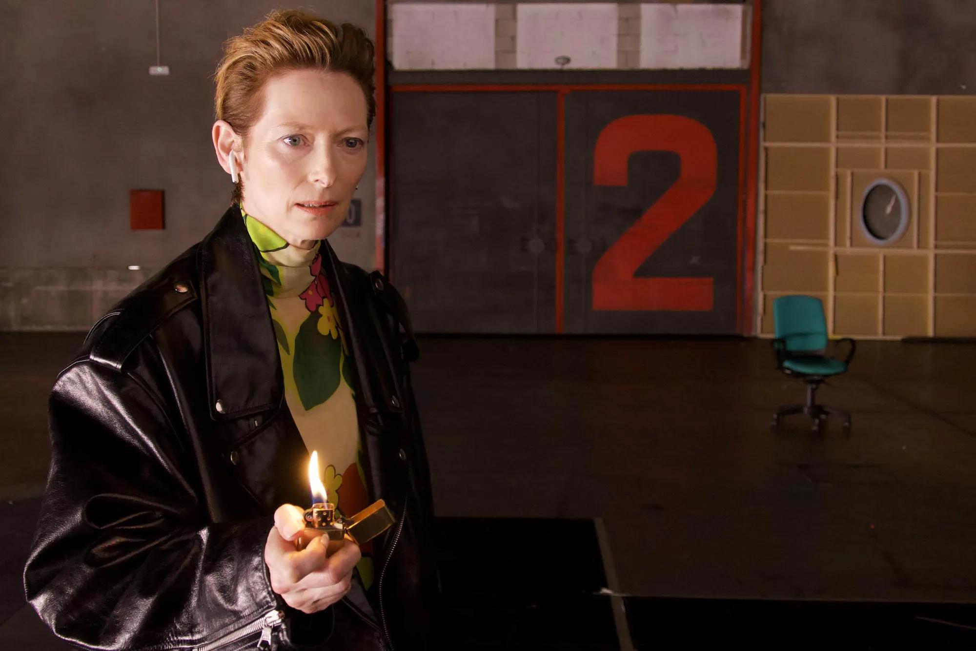 Tilda Swinton holding a lit candle